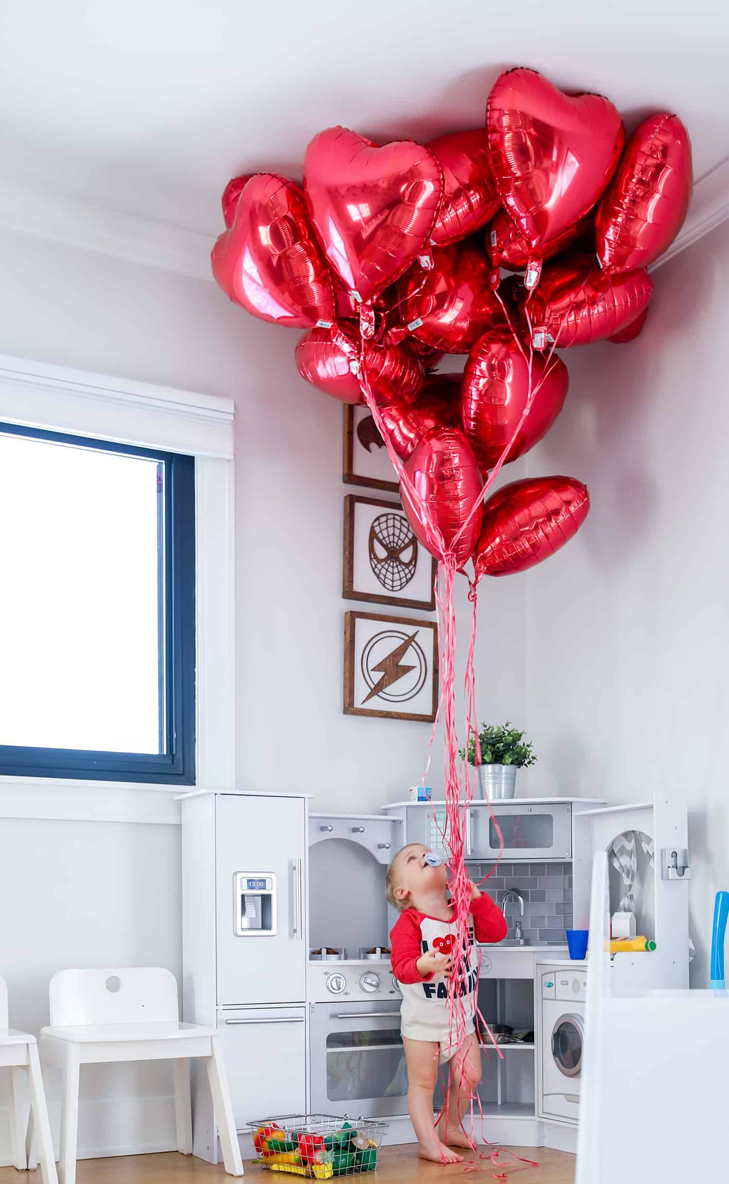 Baby with valentine's balloons