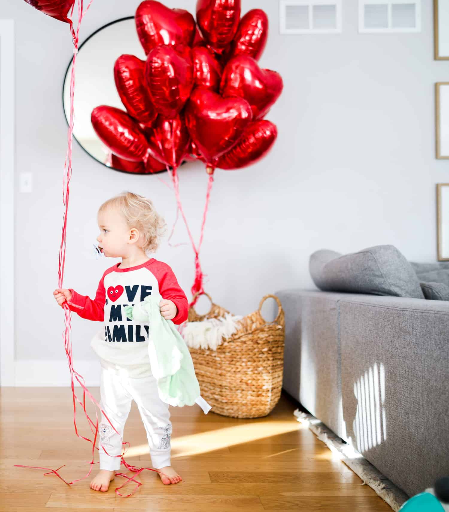 Child with heart balloons