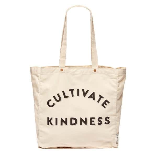 a white tote that reads "cultivate kindness"