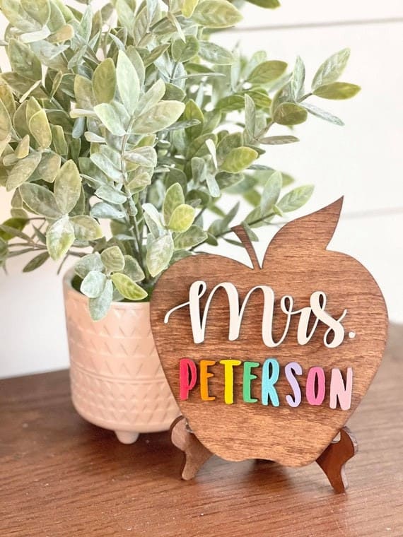 a wooden apple that says Mrs. Peterson 