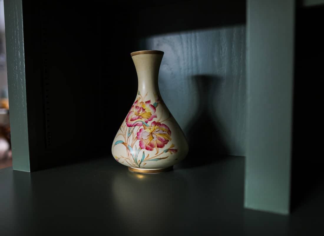 a vintage vase painted with pink flowers