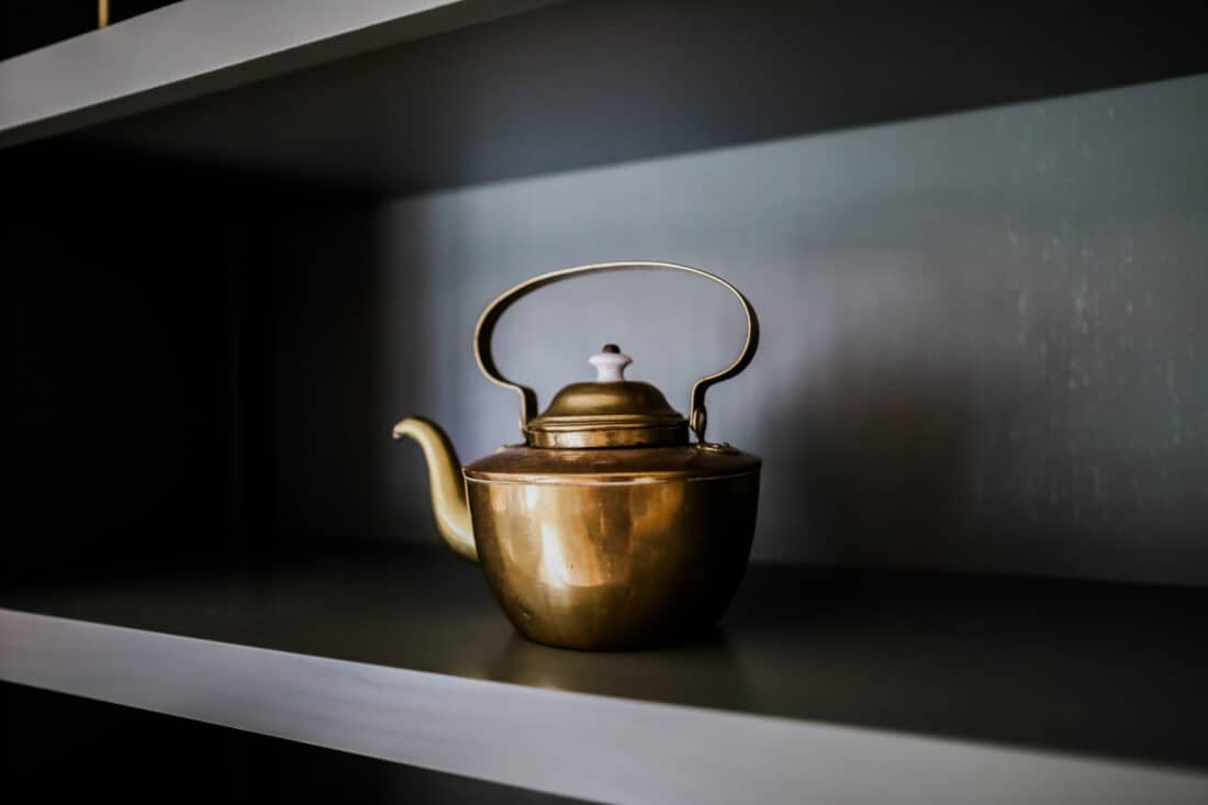 a vintage golden tea kettle