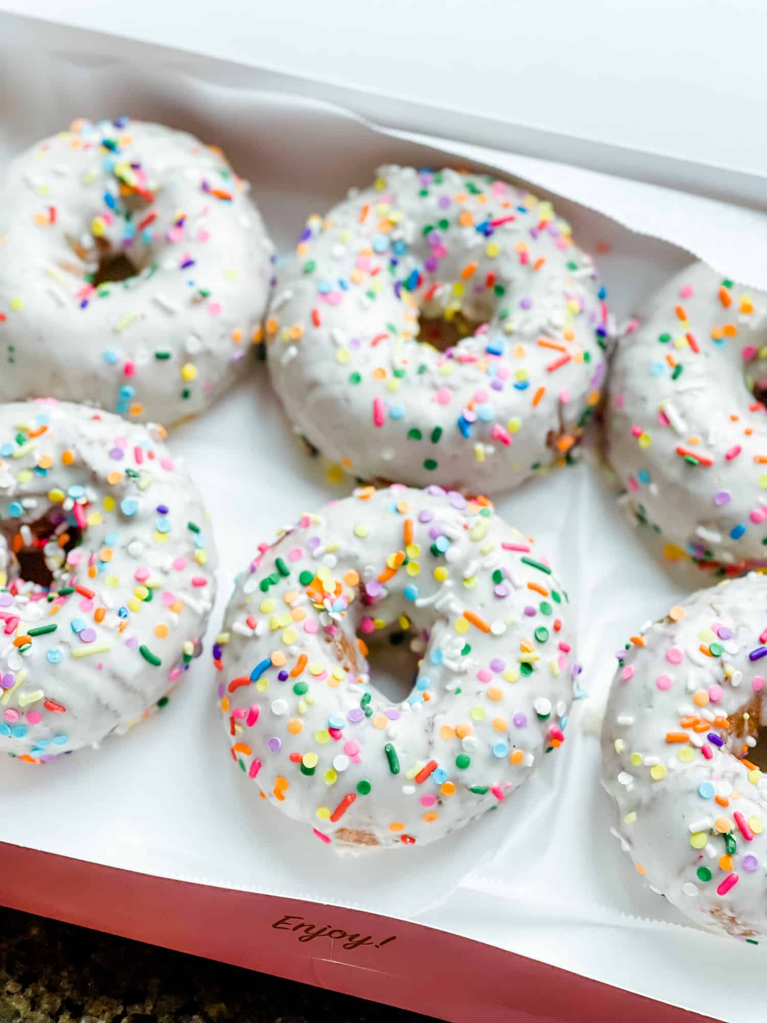 white frosted donuts with sprinkles