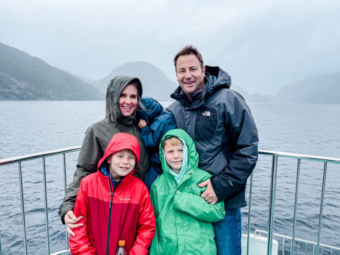 a mom, dad, and their three sons by water in Norway