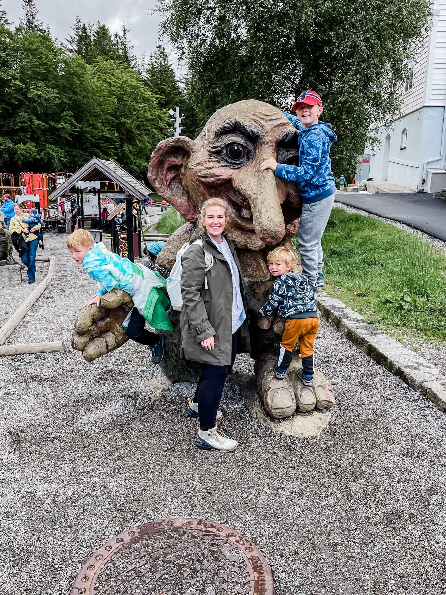 a mom and her three sons by a troll statue in Norway