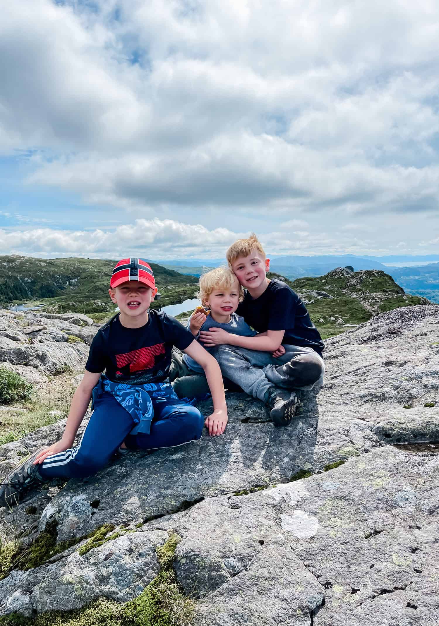 three boys on a hill in Norway